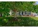 Inviting home with blue shutters, mature trees, and a well-manicured lawn, showcasing great curb appeal at 2412 Chartwell Ln, Graham, NC 27253