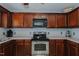 Functional kitchen features dark wood cabinetry and stainless steel range at 2412 Chartwell Ln, Graham, NC 27253