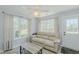 Inviting living room with natural light, a comfortable couch, and neutral tones at 2412 Chartwell Ln, Graham, NC 27253