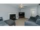 Cozy living room with plush seating, a fireplace, and a ceiling fan for comfortable and stylish relaxation at 2412 Chartwell Ln, Graham, NC 27253