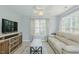 Comfortable living room featuring a neutral color scheme and an abundance of natural light at 2412 Chartwell Ln, Graham, NC 27253