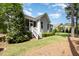 Grassy backyard with privacy trees and a screened porch; ideal for outdoor entertaining at 2421 Beckwith Rd, Apex, NC 27523