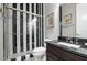 Stylized bathroom featuring black and white striped shower with glass door and marble-tiled floors at 2421 Beckwith Rd, Apex, NC 27523