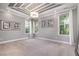 Spacious bedroom with a decorative tray ceiling, chandelier, and plenty of natural light from three windows at 2421 Beckwith Rd, Apex, NC 27523