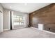 This bedroom is bright, with wood accent wall, and plush carpet at 2421 Beckwith Rd, Apex, NC 27523