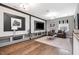 Upstairs entertainment room with hardwood floors, mounted TV, and custom shelving at 2421 Beckwith Rd, Apex, NC 27523