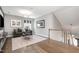Cozy upstairs bonus room featuring hardwood flooring, an accent wall, and ample seating at 2421 Beckwith Rd, Apex, NC 27523