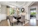 Inviting dining room with fireplace, statement mirror, and natural light at 2421 Beckwith Rd, Apex, NC 27523