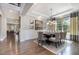 Chic dining room with coffered ceilings, modern chandelier, and large window at 2421 Beckwith Rd, Apex, NC 27523