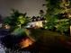Inviting home exterior features beautiful landscaping and outdoor lighting, creating a serene nighttime ambiance at 2421 Beckwith Rd, Apex, NC 27523