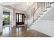 Elegant foyer with hardwood floors, a staircase, and a chandelier, showcasing a grand entrance at 2421 Beckwith Rd, Apex, NC 27523
