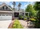 Charming stone home with a two-car garage and an inviting front porch, surrounded by professionally landscaped gardens at 2421 Beckwith Rd, Apex, NC 27523