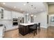 Bright kitchen featuring a large island, stainless steel appliances, and ample cabinet space at 2421 Beckwith Rd, Apex, NC 27523