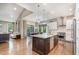 Open-concept kitchen with a large island connecting to a dining and living area at 2421 Beckwith Rd, Apex, NC 27523
