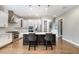 Modern kitchen with a large island, stainless steel appliances, and hardwood floors at 2421 Beckwith Rd, Apex, NC 27523