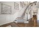 Stylish staircase with wooden banister and decorative wall art, adding a touch of sophistication to the home at 2421 Beckwith Rd, Apex, NC 27523