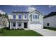 Charming two-story home featuring a light gray and blue color scheme, a two-car garage, and a well-manicured lawn at 248 Alice Trace Place, Angier, NC 27501