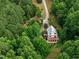 Aerial view of home with surrounding woods and extra living area on a deck at 260 Woody Ln, Oxford, NC 27565