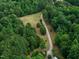 Aerial view of house surrounded by trees with long winding driveway at 260 Woody Ln, Oxford, NC 27565