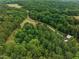 Home surrounded by lush greenery and mature trees at 260 Woody Ln, Oxford, NC 27565