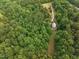 Aerial view of home nestled in woods with long driveway at 260 Woody Ln, Oxford, NC 27565