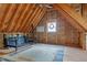 Unfinished attic space featuring exposed rafters, a ceiling fan, natural light, and rustic charm at 260 Woody Ln, Oxford, NC 27565