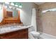 Bathroom featuring wooden vanity with granite countertop and shower at 260 Woody Ln, Oxford, NC 27565
