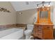 Bathroom features a vanity, toilet, and tub with stylish tile, offering functionality and relaxation at 260 Woody Ln, Oxford, NC 27565