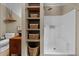 Bright bathroom features open shelving, toilet, and walk-in shower with white tile at 260 Woody Ln, Oxford, NC 27565