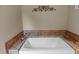 Close-up of a clean bathtub featuring tile surround and elegant faucet hardware at 260 Woody Ln, Oxford, NC 27565