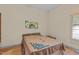 Simple bedroom design featuring a bed with neutral bedding and natural light from the window at 260 Woody Ln, Oxford, NC 27565