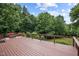Spacious wooden deck with seating, offering panoramic views of the surrounding greenery at 260 Woody Ln, Oxford, NC 27565