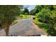 Long gravel driveway lined with trees and landscaping leading to the residence at 260 Woody Ln, Oxford, NC 27565