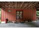 Covered entryway with double glass doors and wood ceiling featuring a seating area at 260 Woody Ln, Oxford, NC 27565