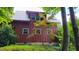 Rustic exterior displaying unique architectural details and lush greenery, enhancing its curb appeal at 260 Woody Ln, Oxford, NC 27565