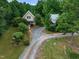 Exterior home view with gravel driveway and garage at 260 Woody Ln, Oxford, NC 27565
