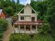 Rear exterior view of home with an upper level deck and covered lower level at 260 Woody Ln, Oxford, NC 27565