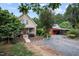 Exterior view of the house with a stone walkway, a red building, and parking area at 260 Woody Ln, Oxford, NC 27565