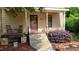 Inviting front porch with stone steps, landscaping, and a cozy seating area at 260 Woody Ln, Oxford, NC 27565