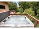 Relaxing hot tub on a wooden deck, with a scenic view of the surrounding landscape at 260 Woody Ln, Oxford, NC 27565