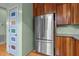 Modern kitchen with stainless steel appliances, custom cabinetry, and a unique colorful door at 260 Woody Ln, Oxford, NC 27565