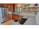 Bright kitchen with stainless steel appliances, custom cabinets, and large windows with a view at 260 Woody Ln, Oxford, NC 27565