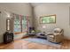 Cozy living area with a wood burning stove and a large window with views of the outdoors at 260 Woody Ln, Oxford, NC 27565