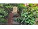 Stone steps lead to a secluded entrance framed by lush greenery, creating a tranquil welcome at 260 Woody Ln, Oxford, NC 27565