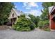 Exterior angle of home with gravel parking and a red outbuilding at 260 Woody Ln, Oxford, NC 27565