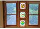 Bright windows offering scenic views, enhanced by colorful stained glass at 260 Woody Ln, Oxford, NC 27565