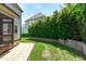 Home exterior view from the backyard showcasing landscaping and privacy fence at 2712 Peachleaf St, Raleigh, NC 27614