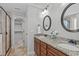 Bright bathroom features double vanity with granite countertops and walk-in shower at 2712 Peachleaf St, Raleigh, NC 27614