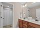 Bathroom features double sink vanity, neutral walls, tile floors, and shower/tub combo at 2712 Peachleaf St, Raleigh, NC 27614