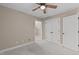 Carpeted bedroom showing closet, walls, and ceiling fan at 2712 Peachleaf St, Raleigh, NC 27614